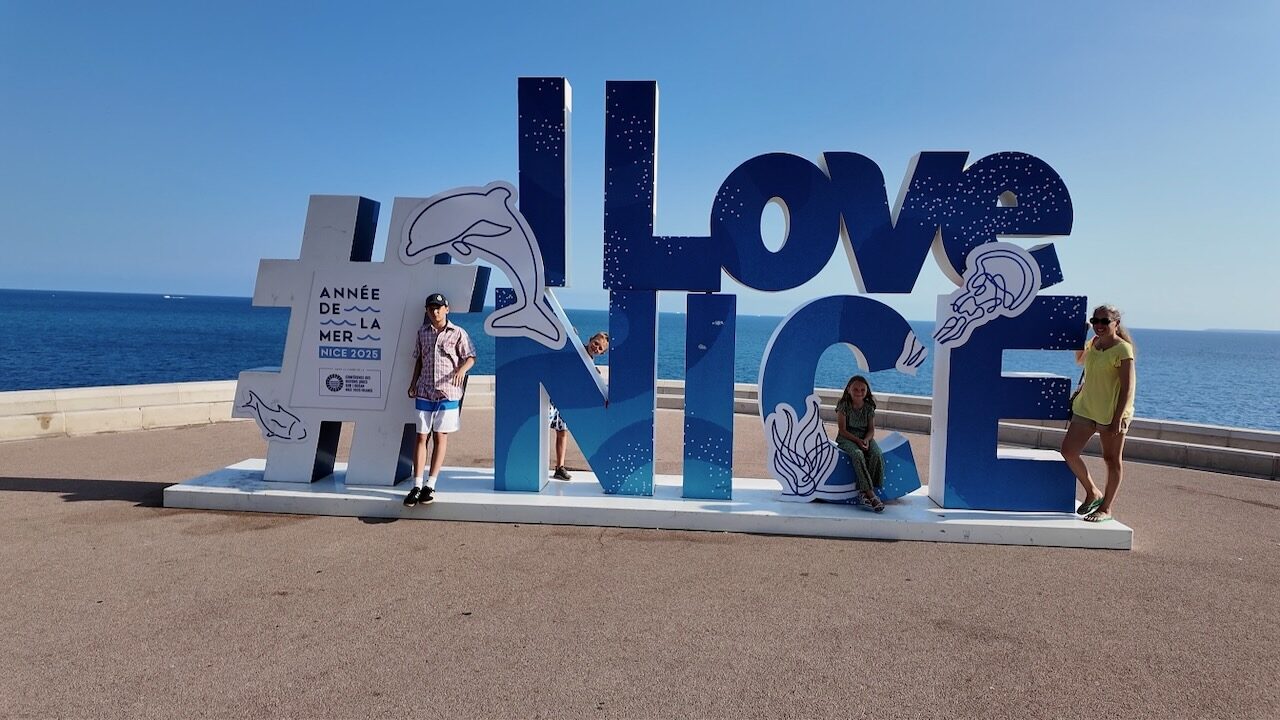 Perhe I Love Nice -kirjainten edessä Nizzassa